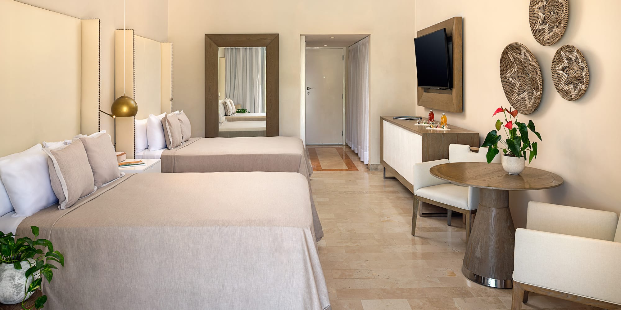 a room with two beds and a television