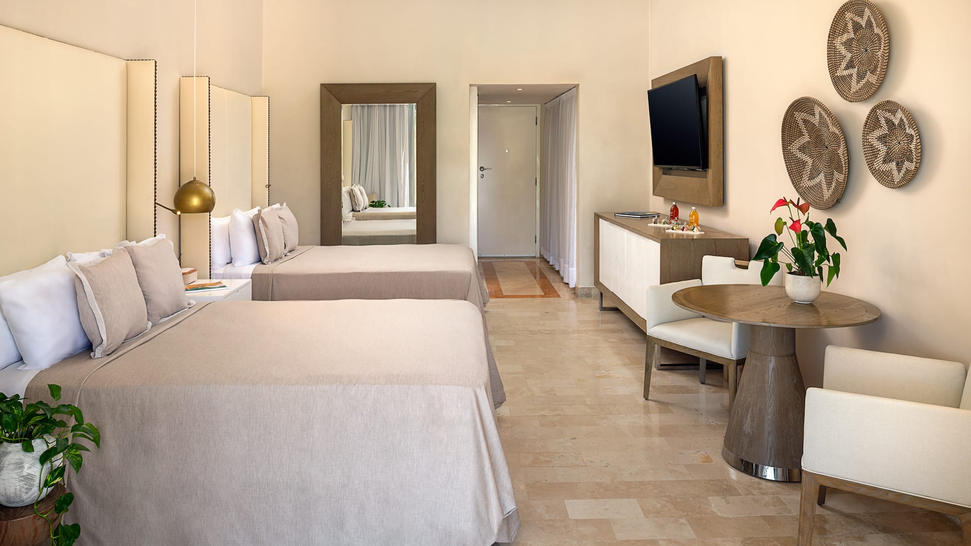 a room with two beds and a television