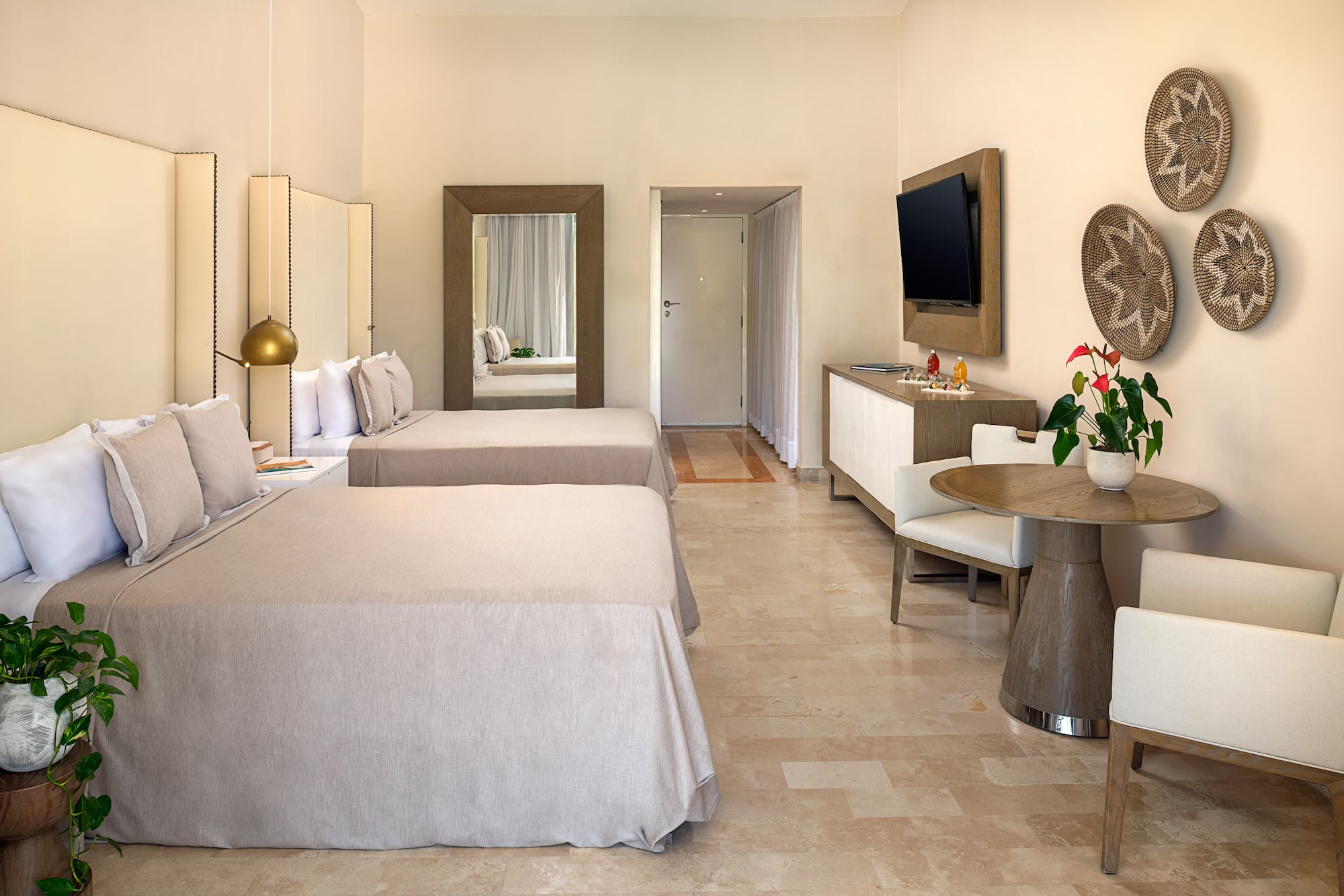 a room with two beds and a television