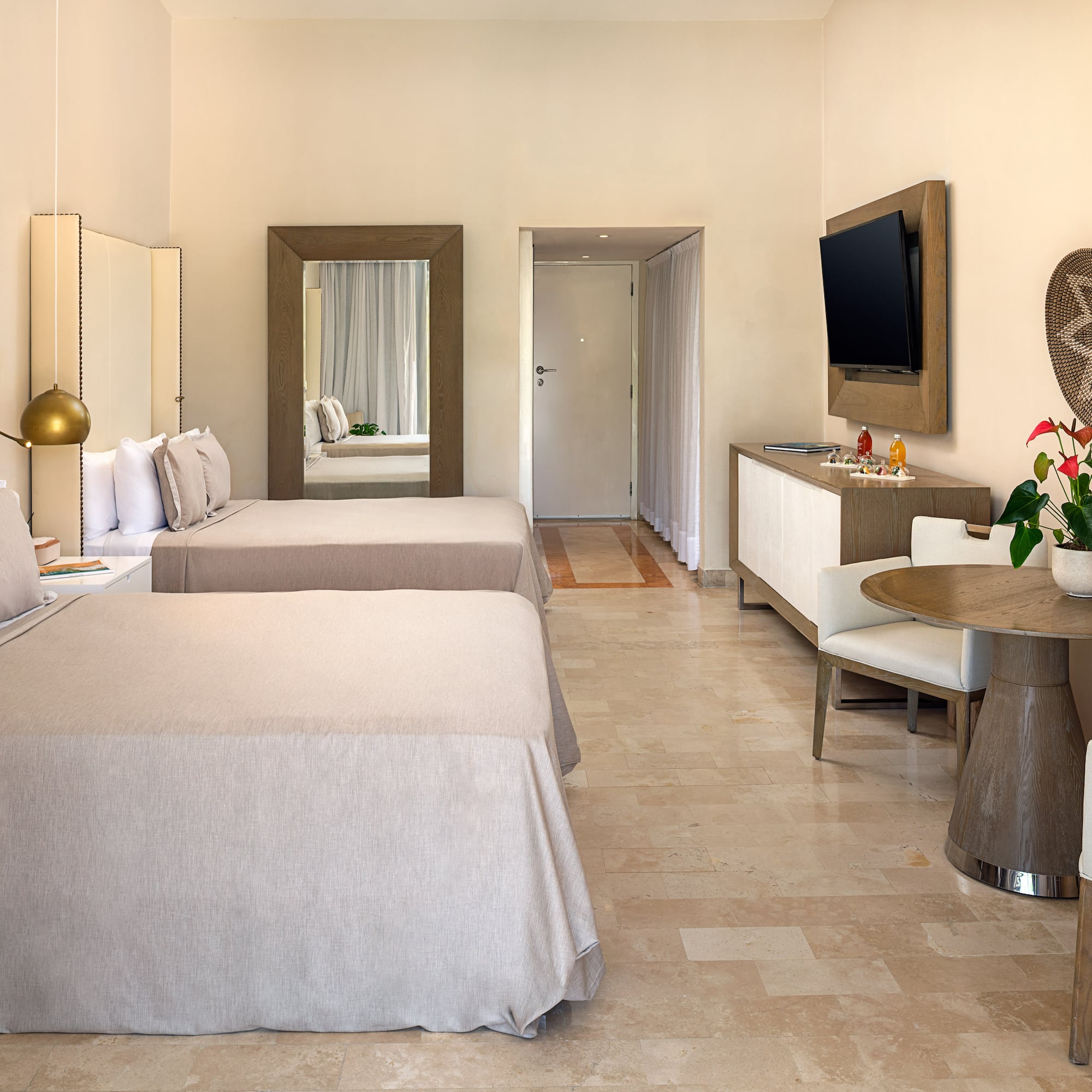 a room with two beds and a television