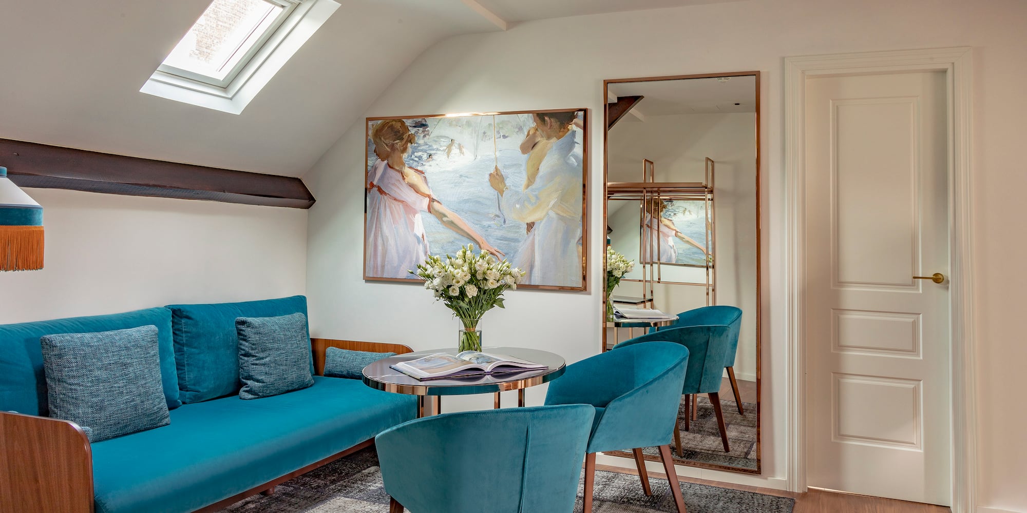 a room with a couch and a table and chairs