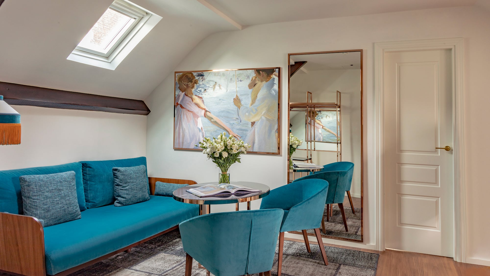 a room with a couch and a table and chairs