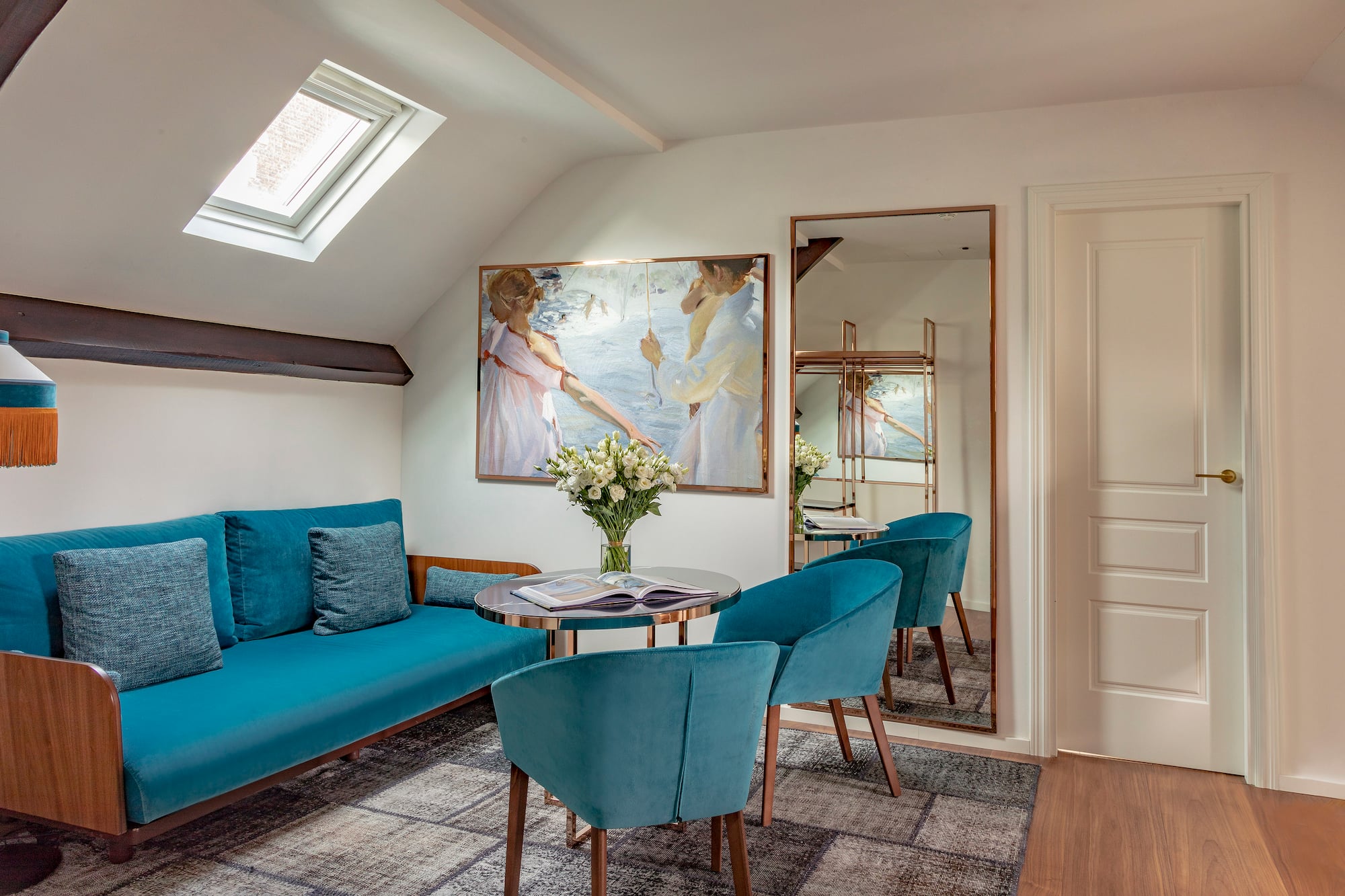 a room with a couch and a table and chairs