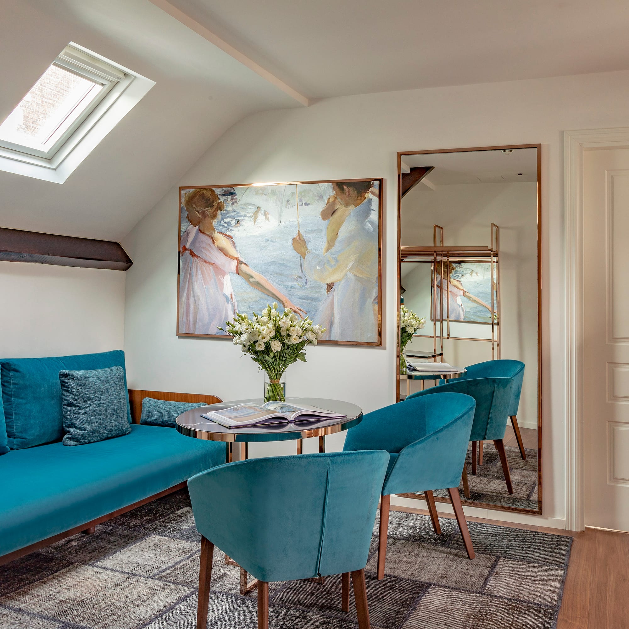 a room with a couch and a table and chairs