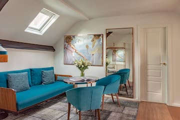 a room with a couch and a table and chairs
