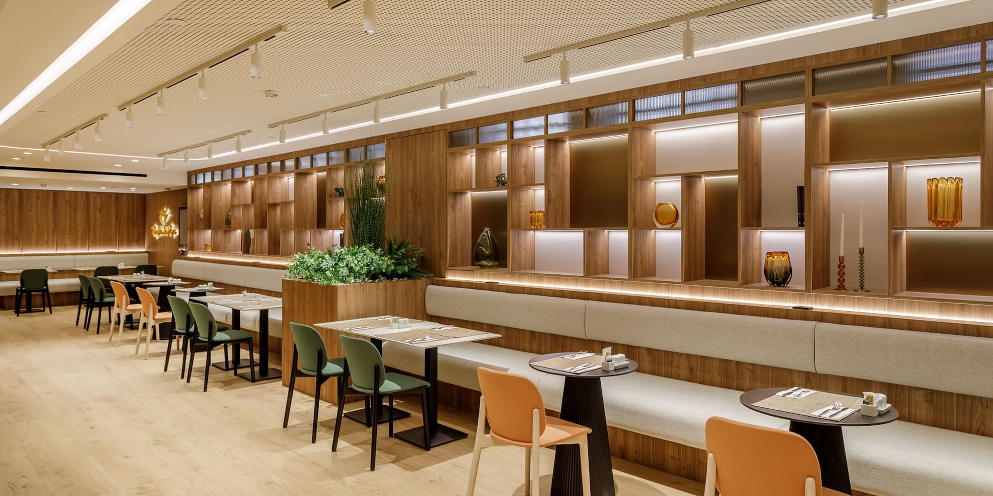Contemporary restaurant with wooden interior, banquette seating, and stylish lighting.