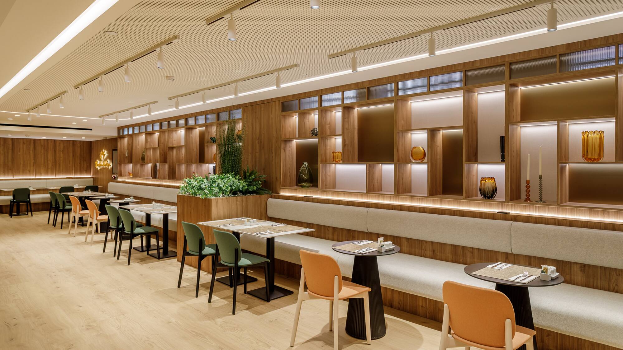 Contemporary restaurant with wooden interior, banquette seating, and stylish lighting.