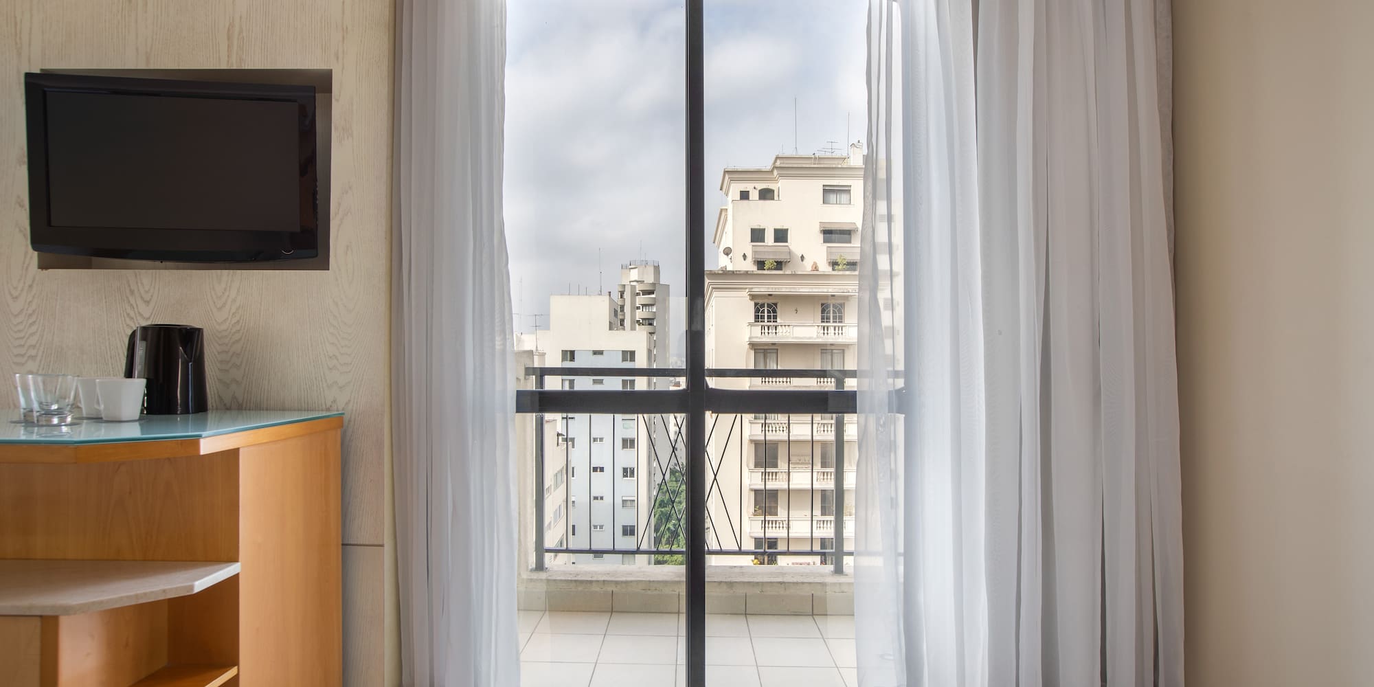 a room with a balcony and a television