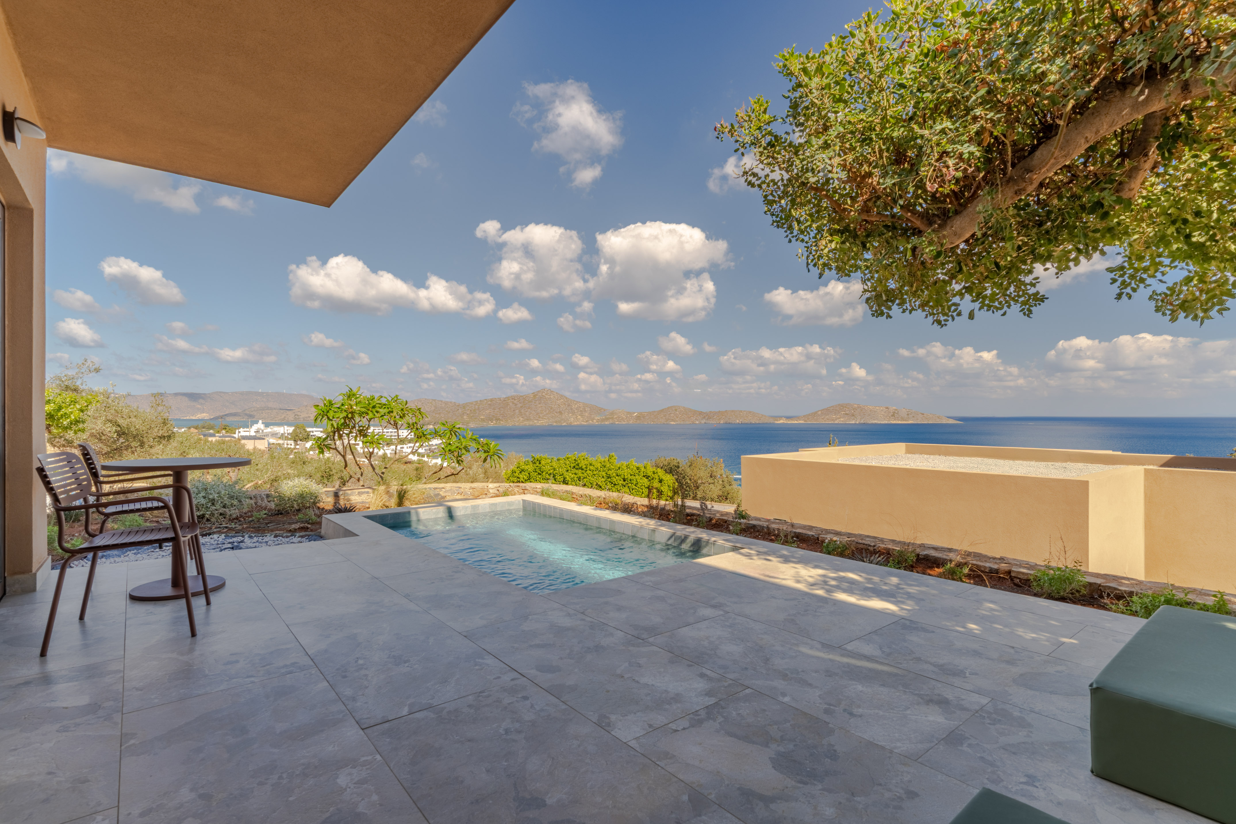 Private plunge pool and patio with a stunning ocean and island view.