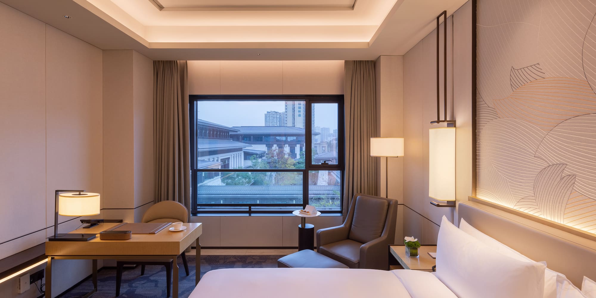 a room with a bed and a table and chairs