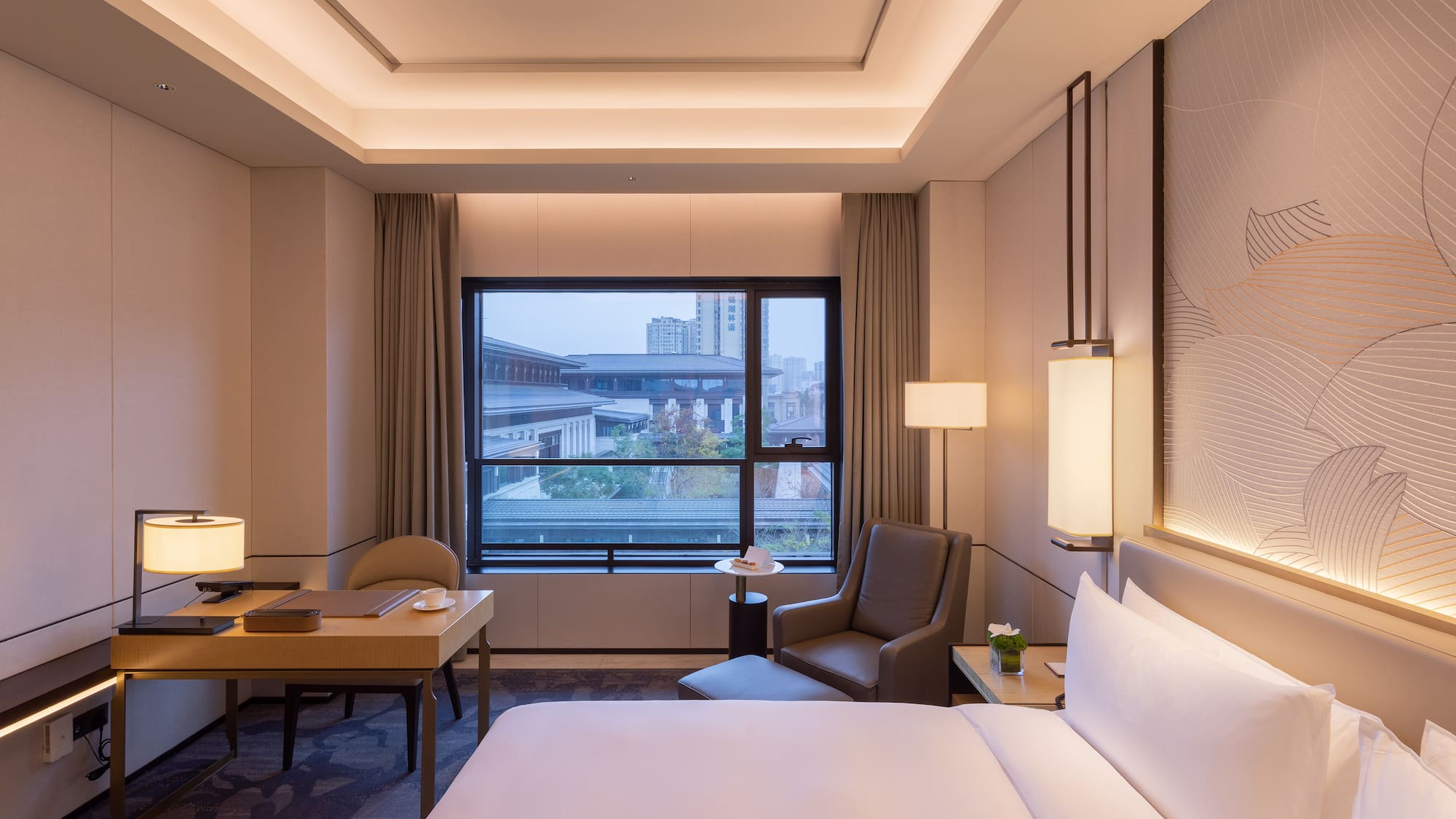 a room with a bed and a table and chairs