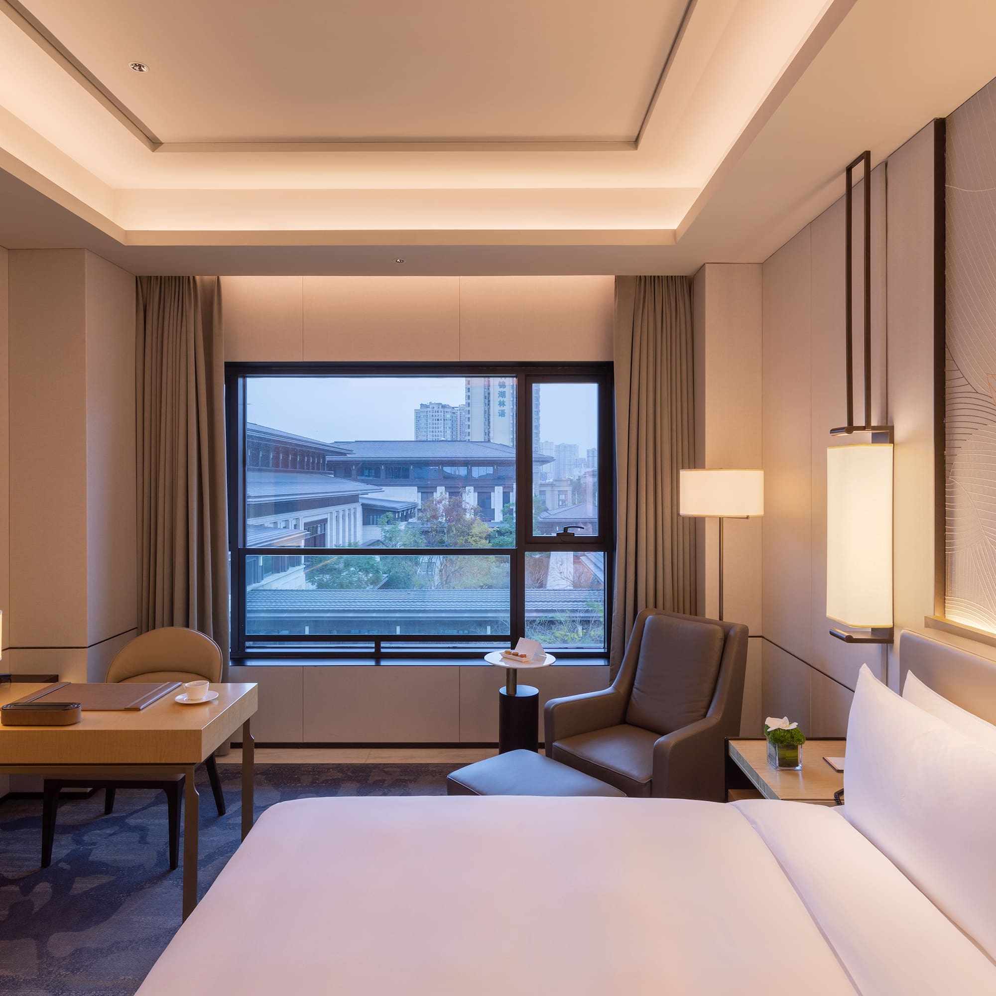 a room with a bed and a table and chairs