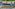 Aerial view of luxury beach resort with private pools, palm trees, and ocean.