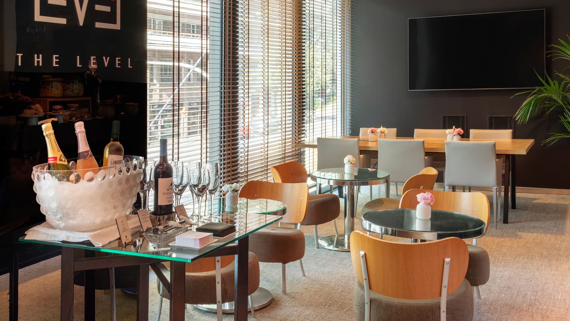 a room with a table and chairs and a television