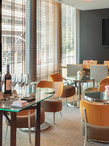 a room with a table and chairs and a television