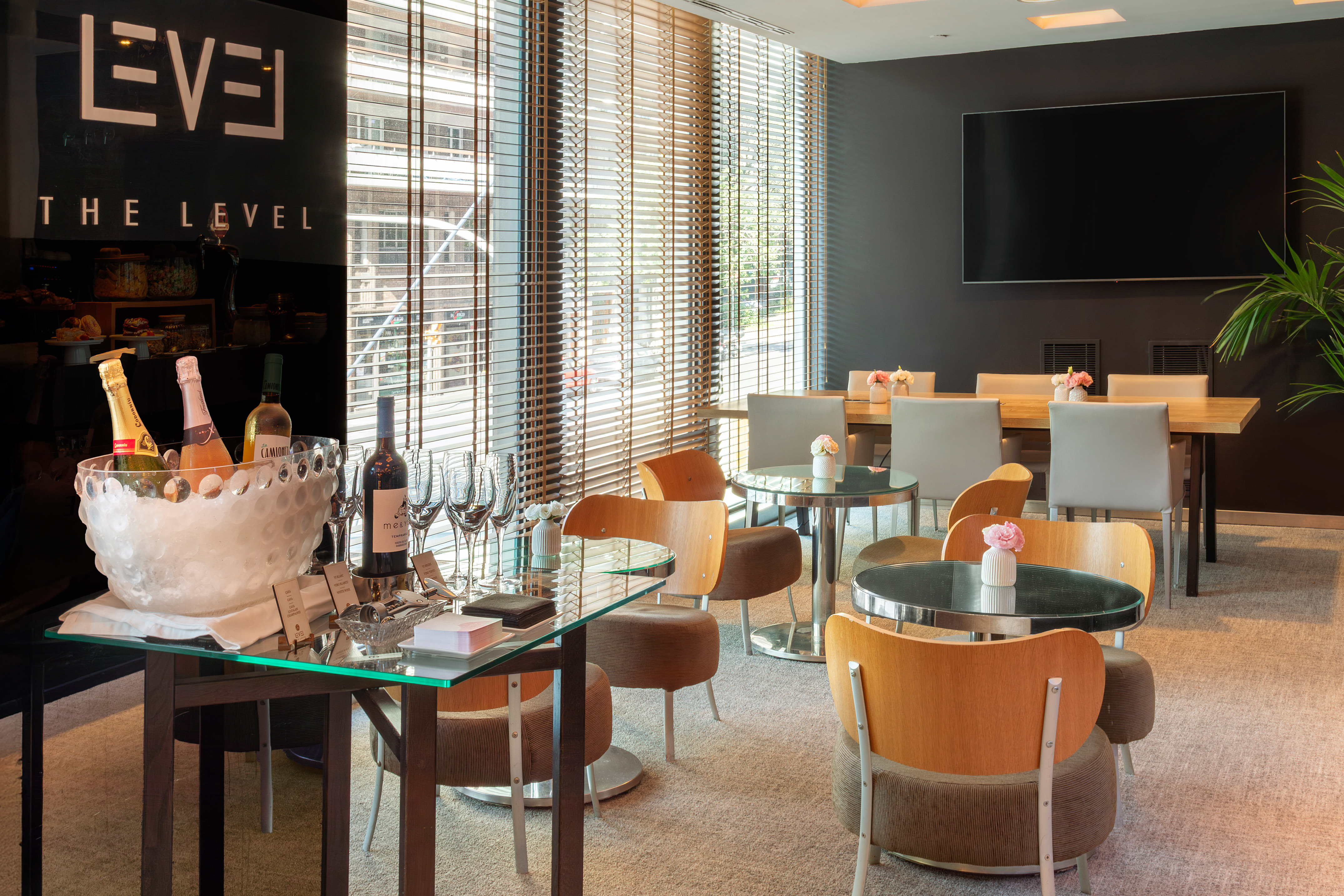 Executive hotel lounge with wine bar, comfortable seating, and meeting area.