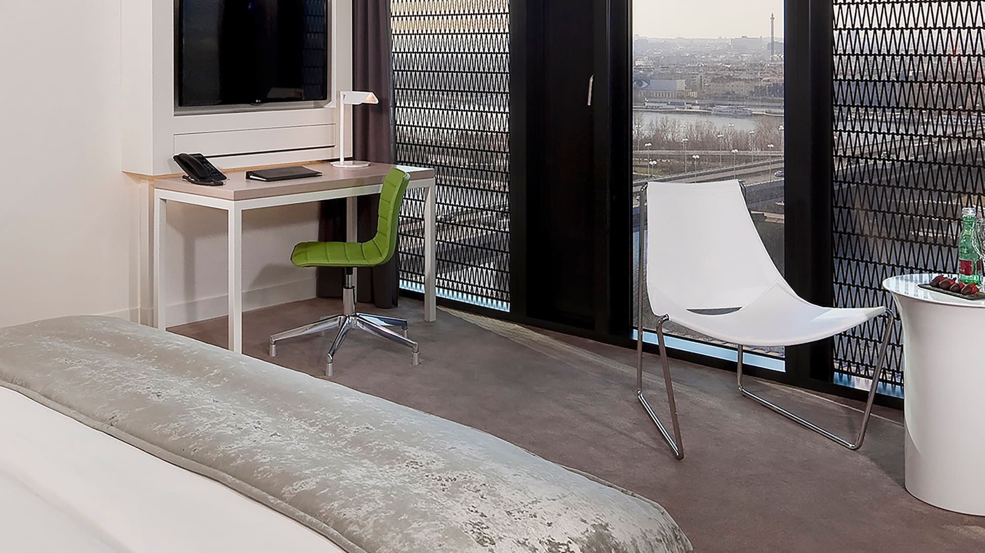 a room with a bed and a desk and chair