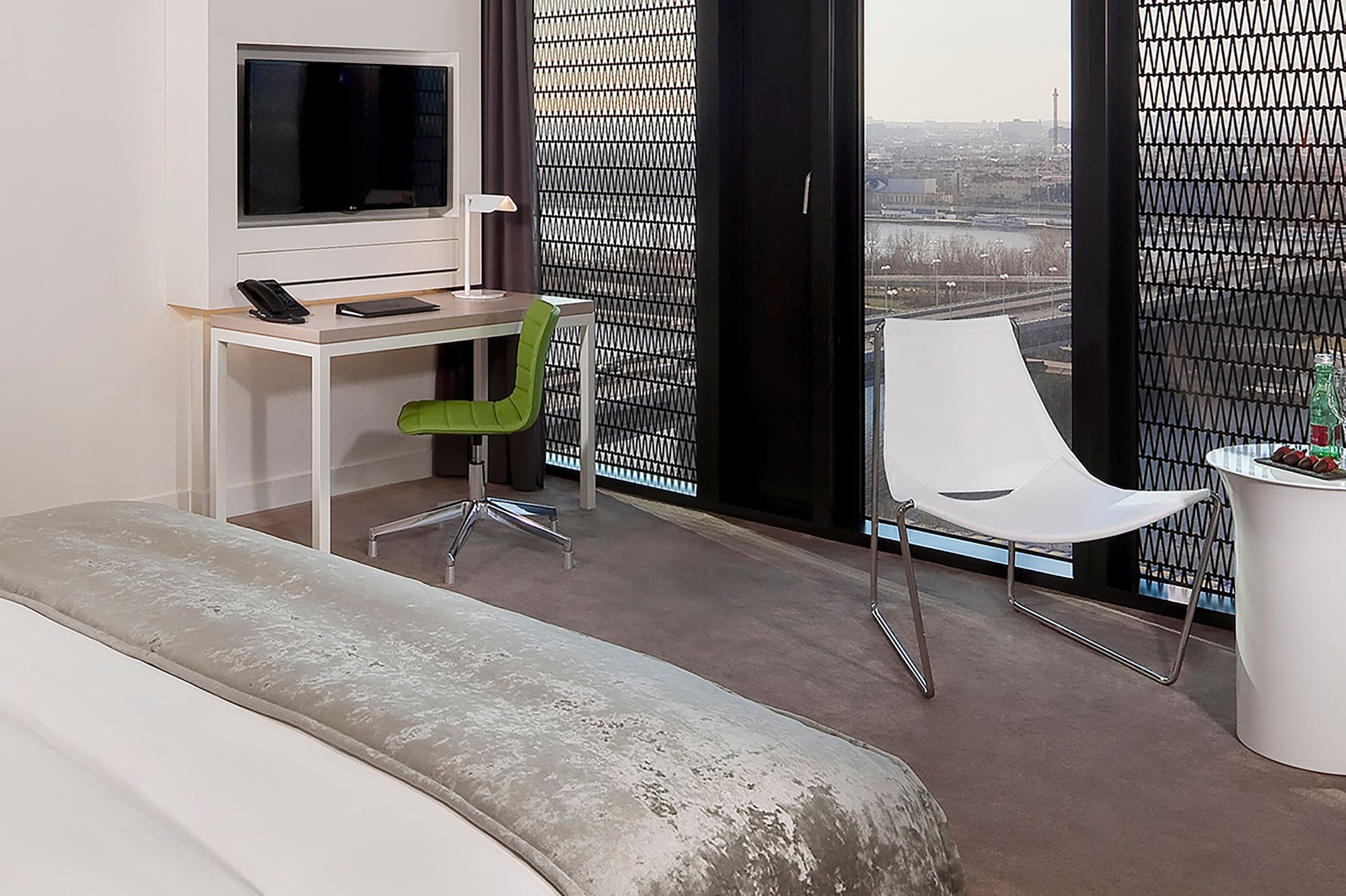 a room with a bed and a desk and chair