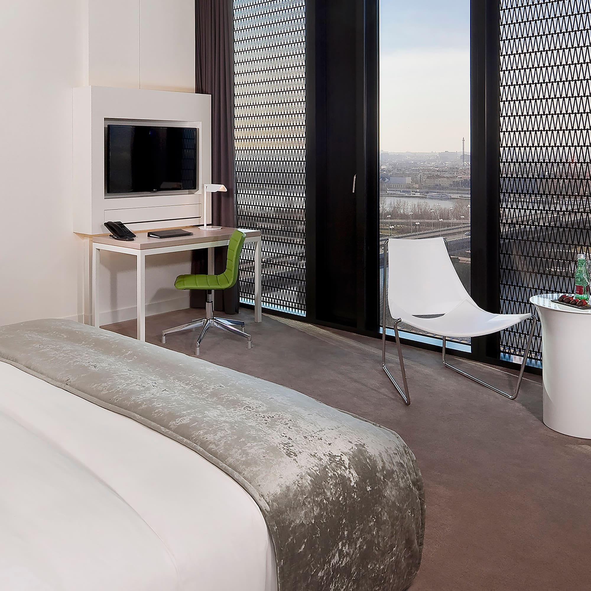 a room with a bed and a desk and chair