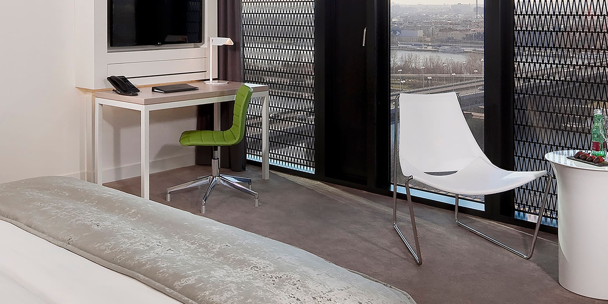 a room with a bed and a desk and chair