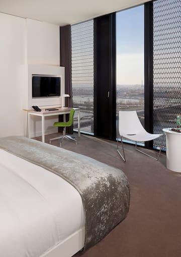 a room with a bed and a desk and chair