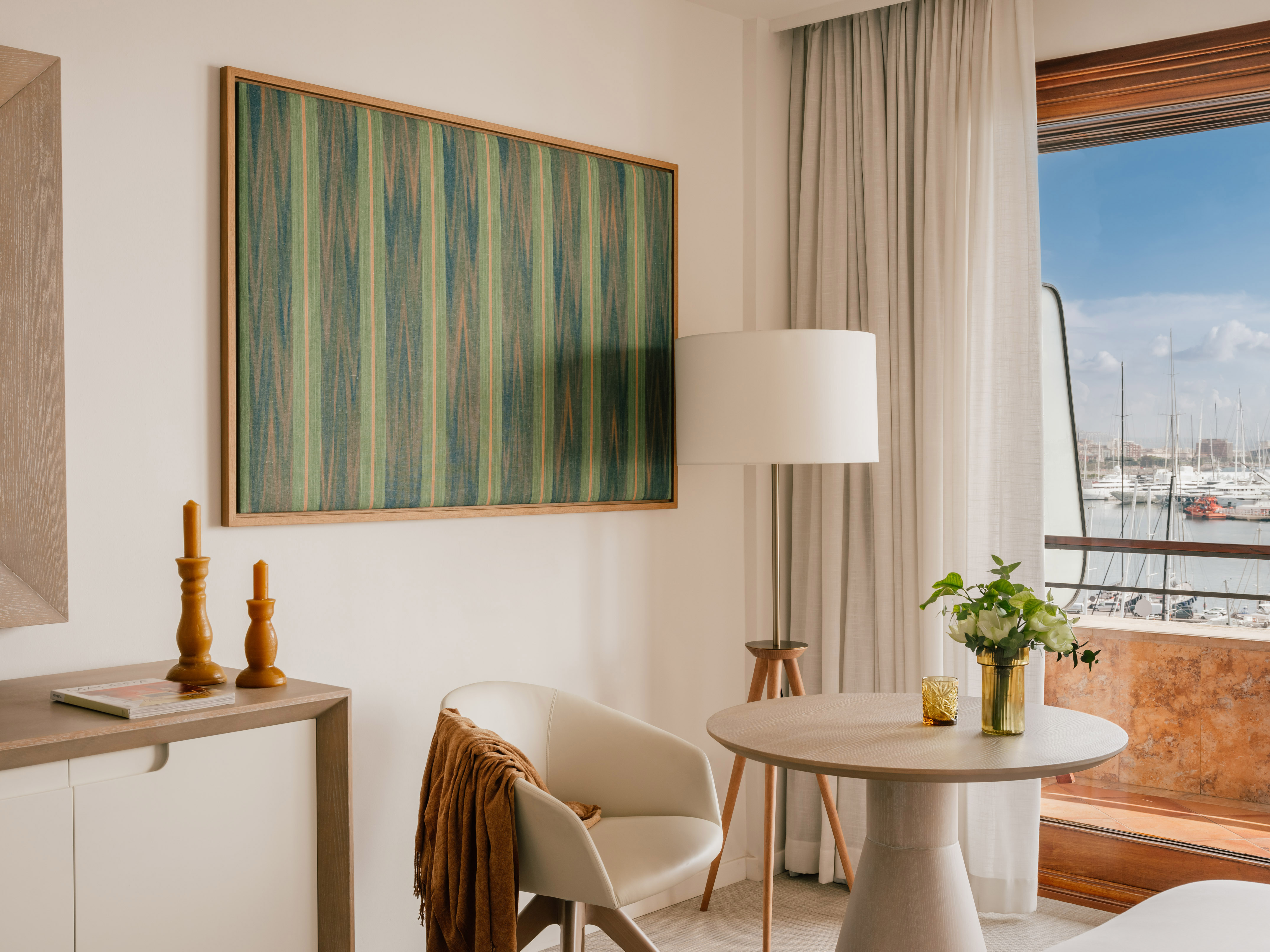Luxury suite with harbor view, abstract art, and contemporary interior.