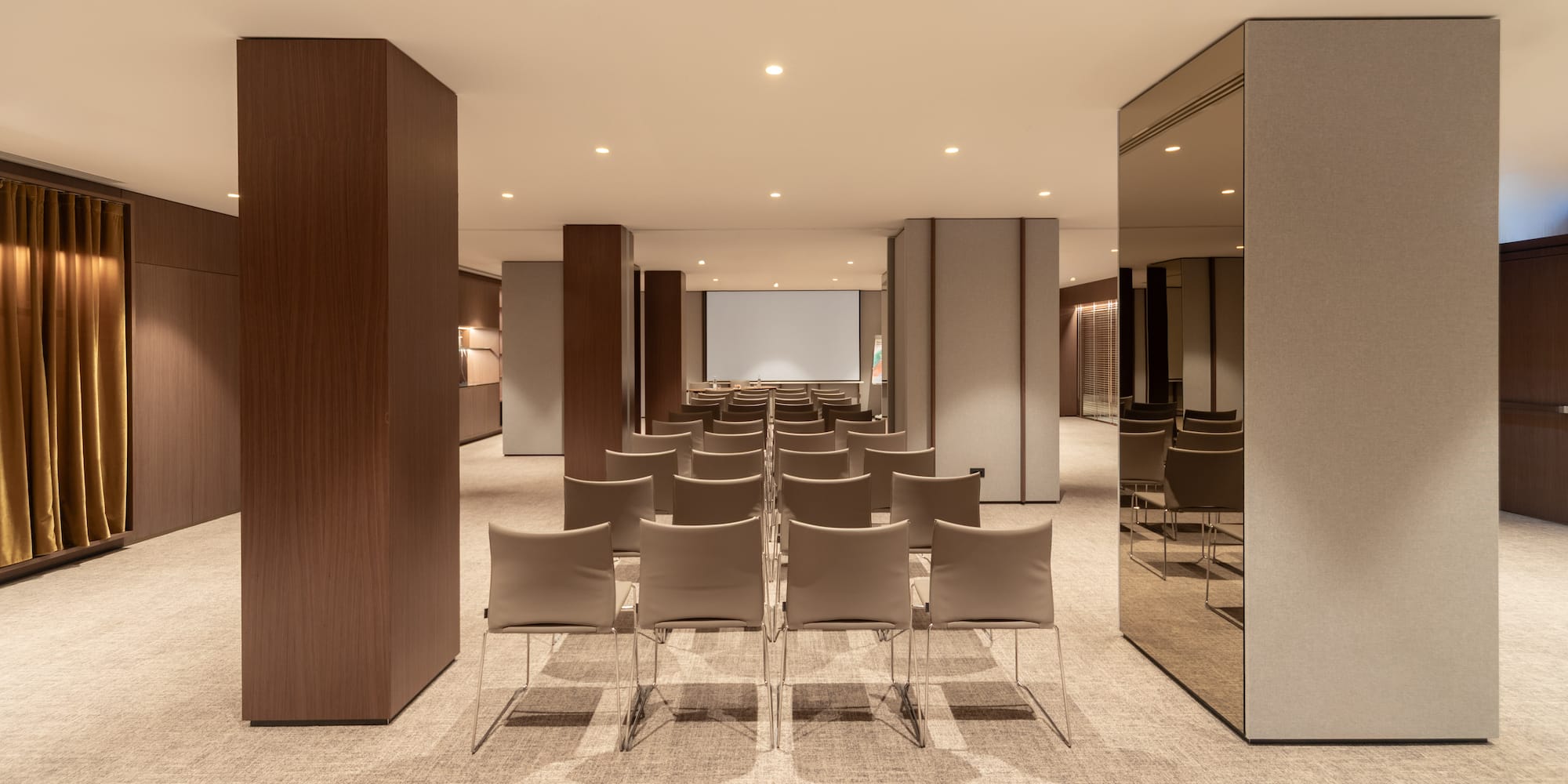 a room with chairs and a projector screen