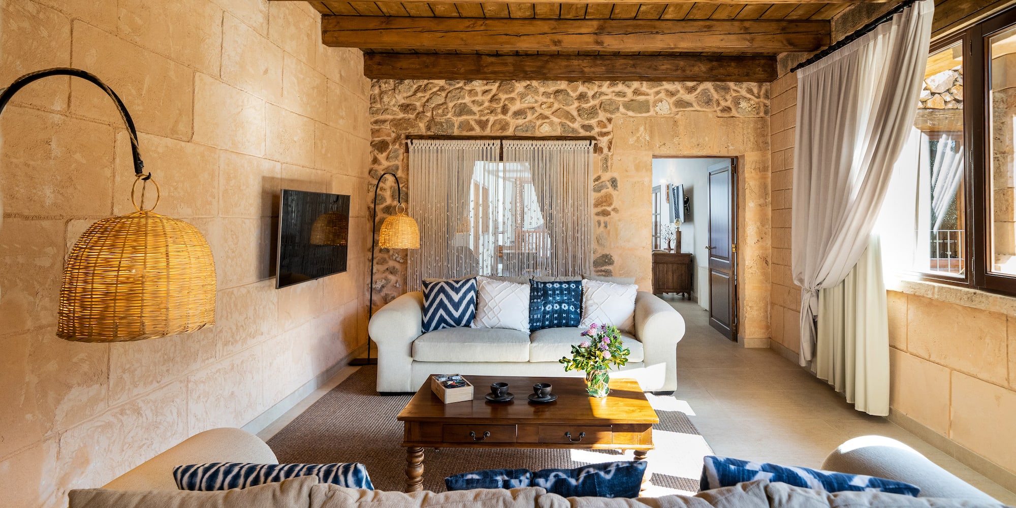 a living room with a stone wall and a couch
