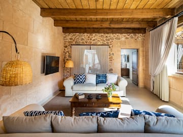 a living room with a stone wall and a couch