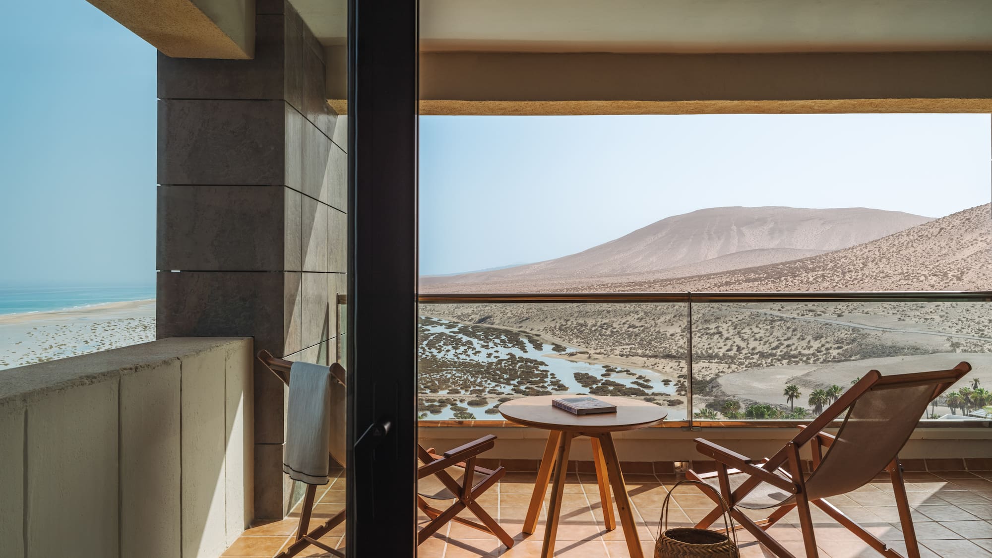 a balcony with chairs and a table