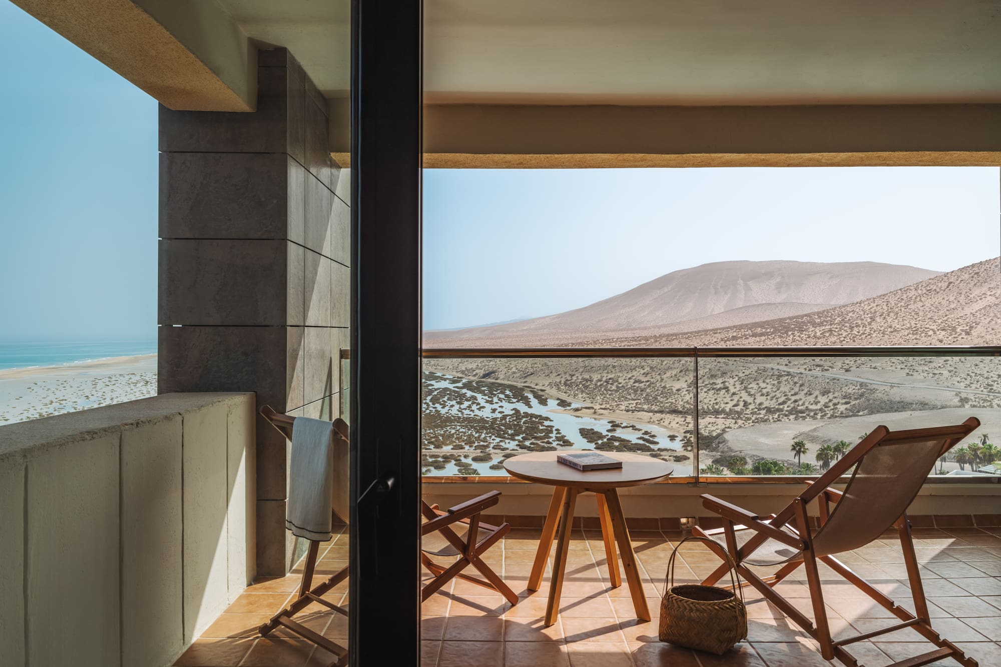 a balcony with chairs and a table