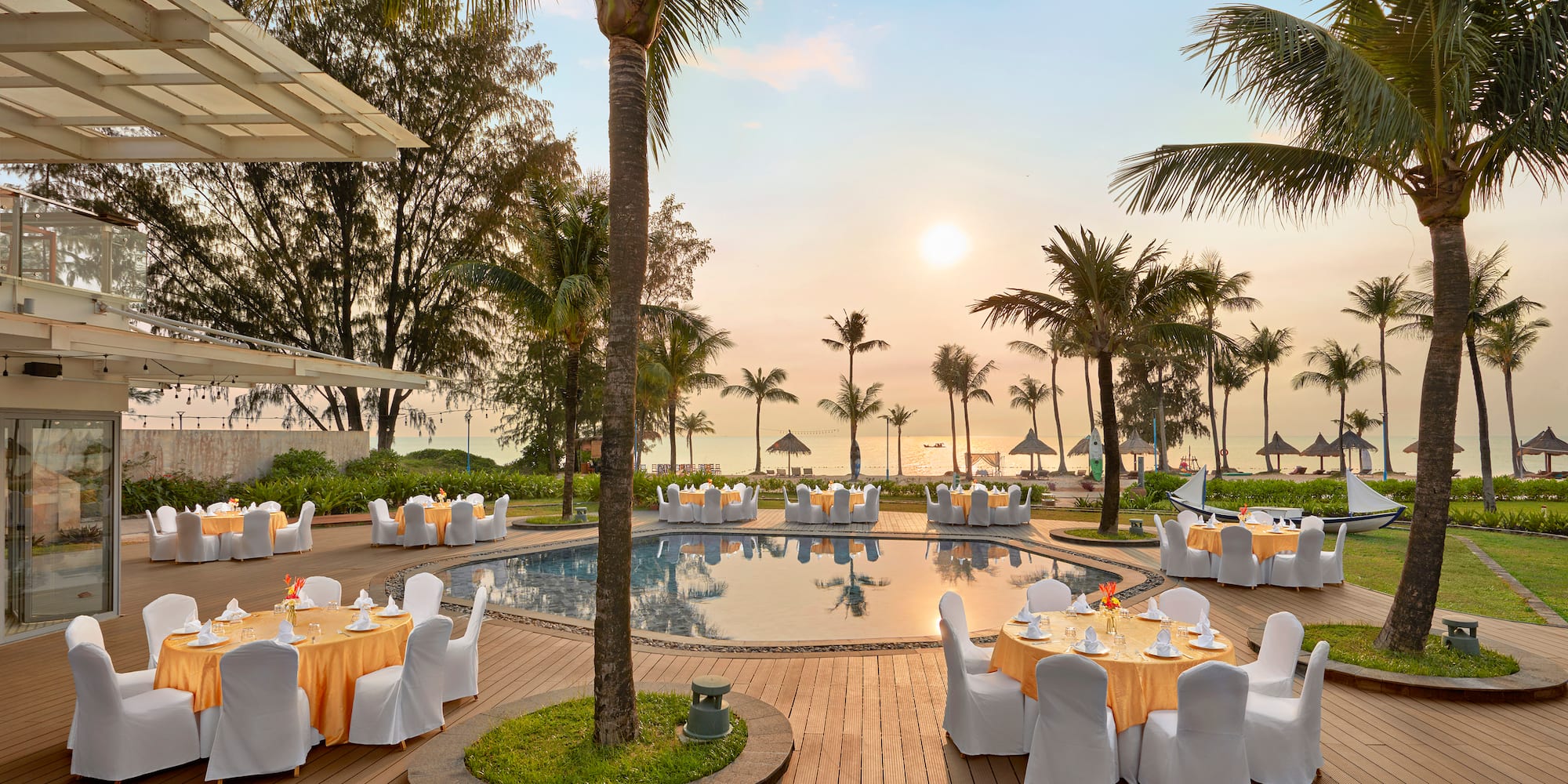 a pool with tables and chairs around it