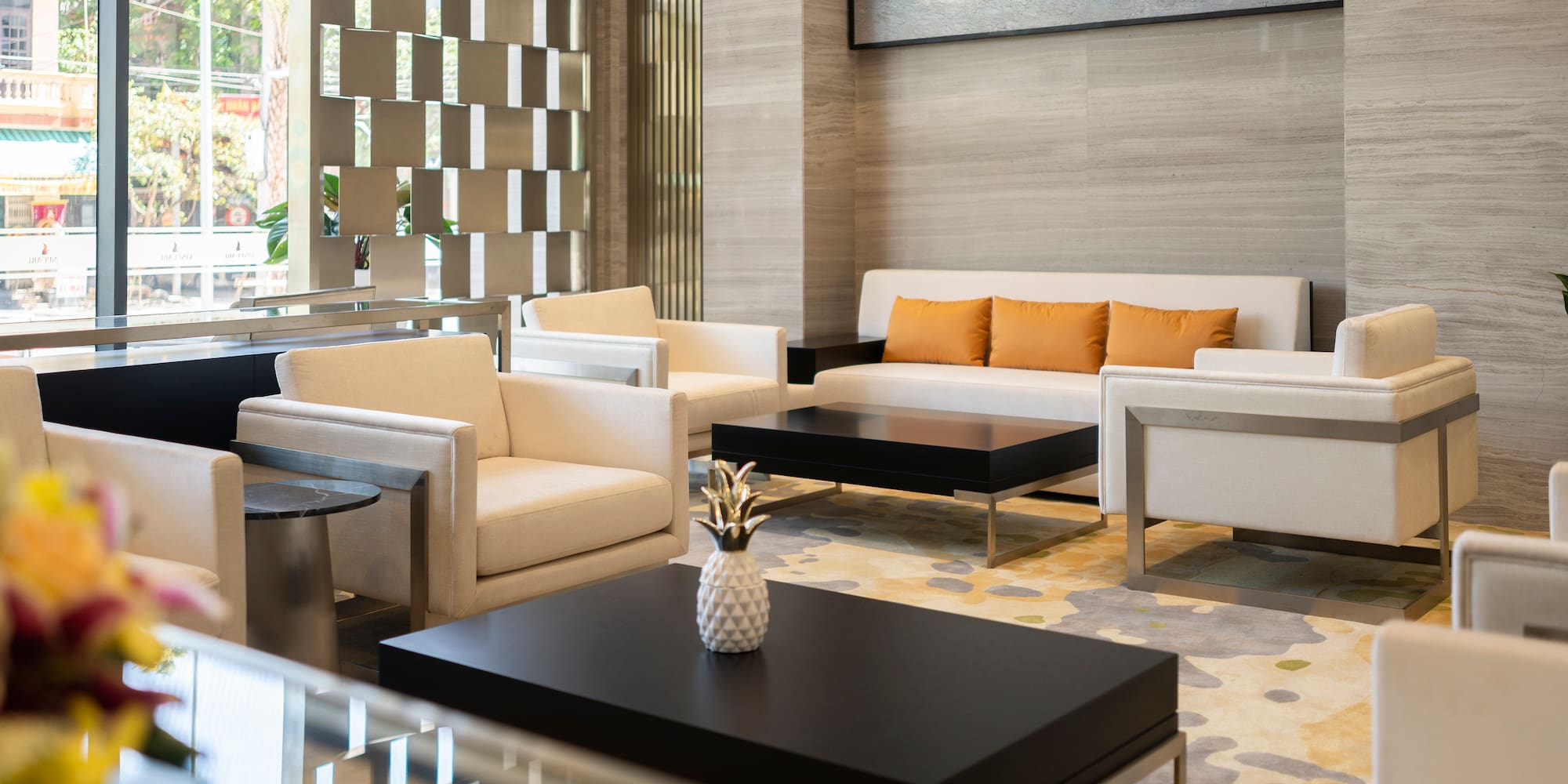 a room with white furniture and a black coffee table