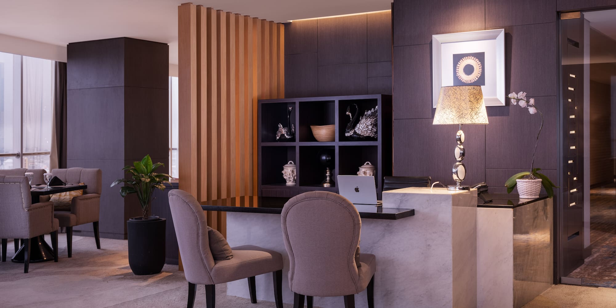 a room with a desk and chairs