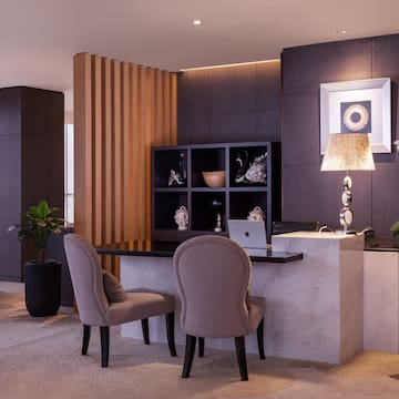 a room with a desk and chairs