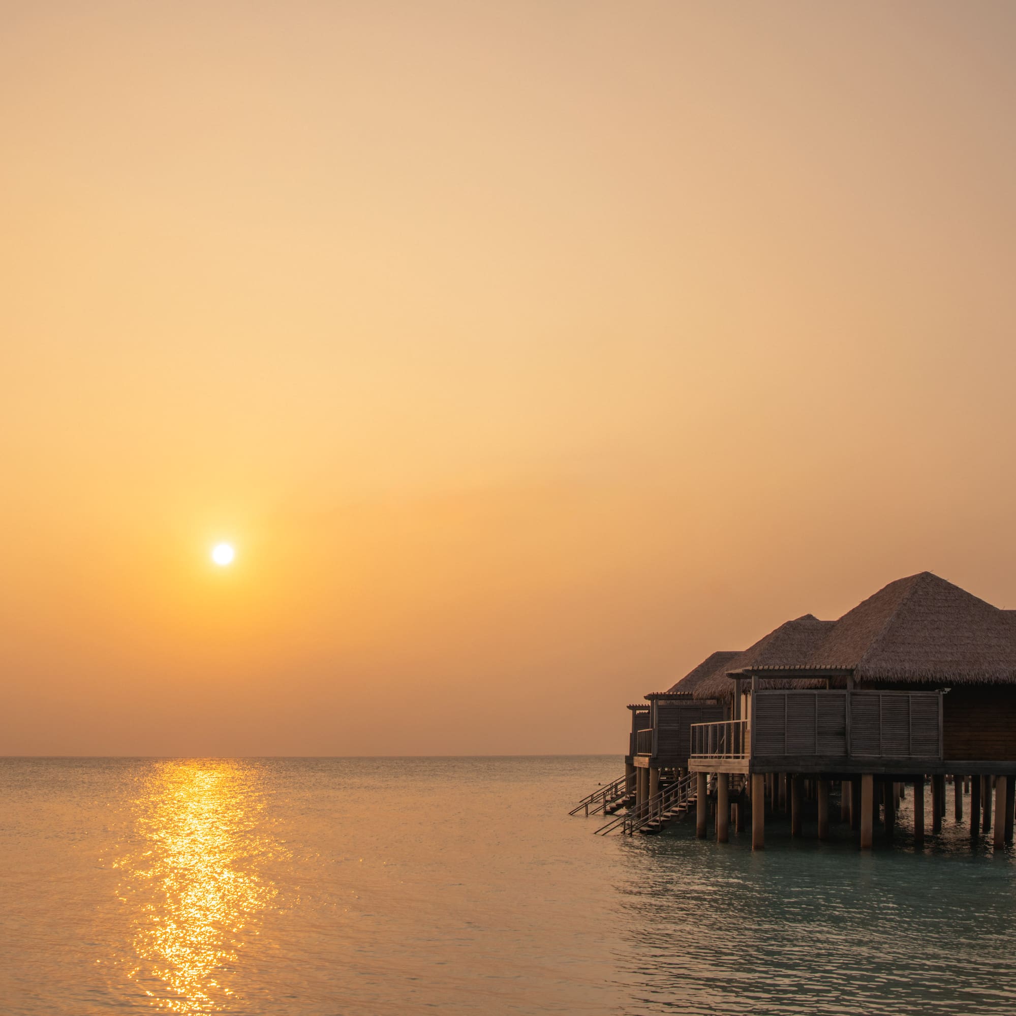 a group of huts on stilts on water