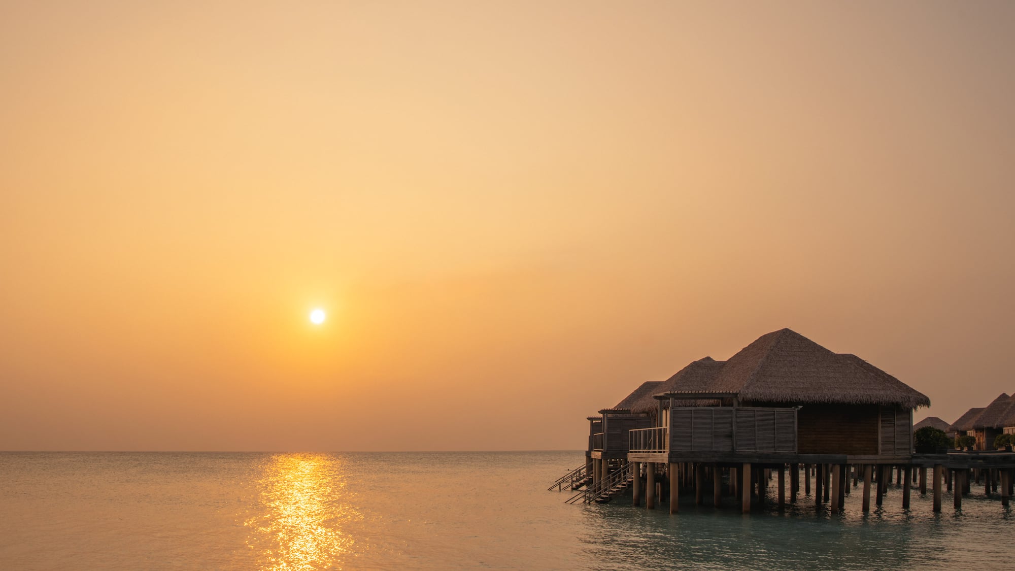 a group of huts on stilts on water