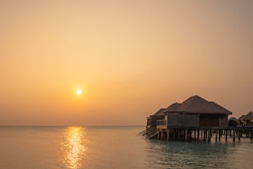 a group of huts on stilts on water