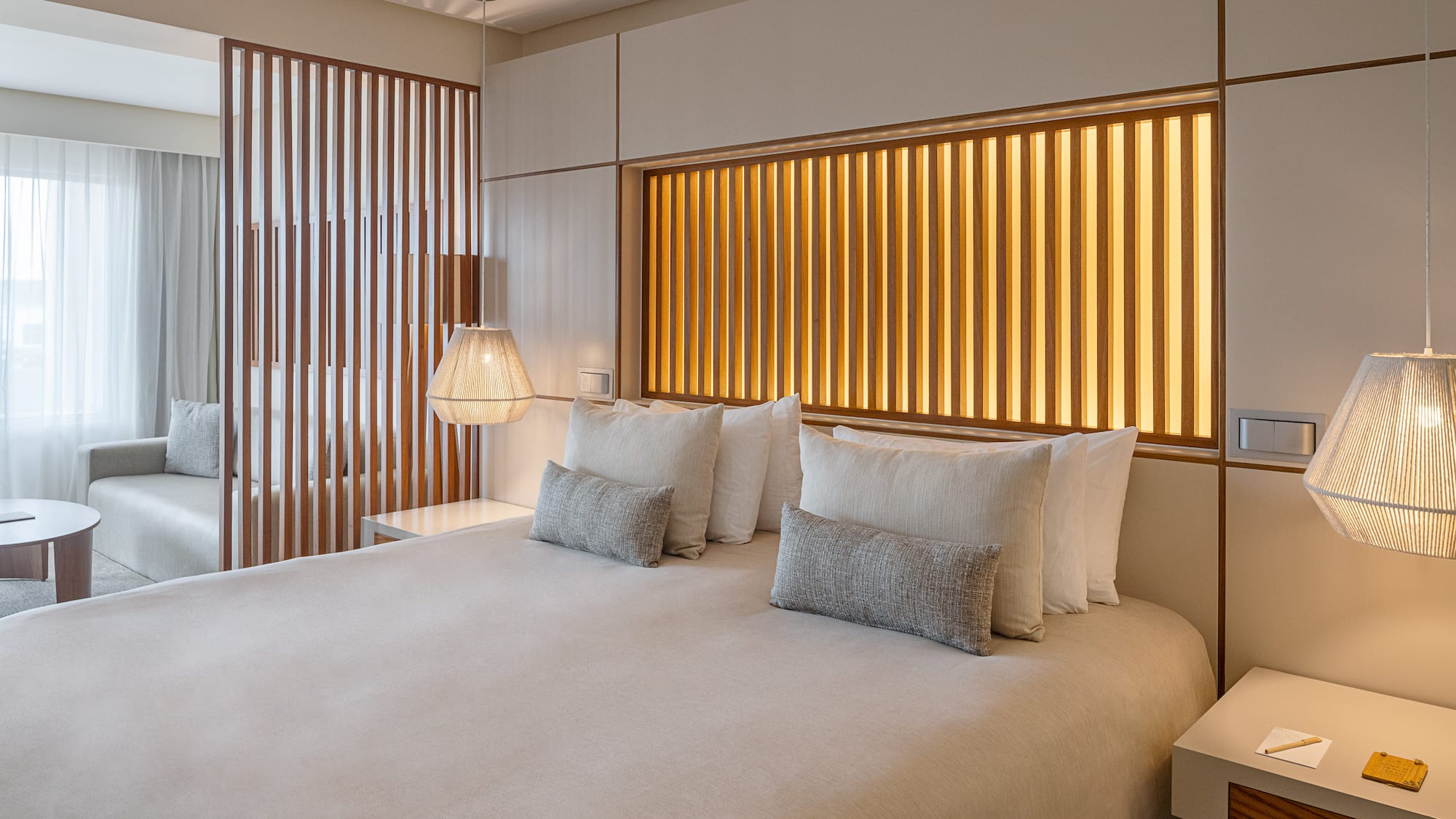 a bed with pillows and lamps in a room