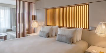 a bed with pillows and lamps in a room