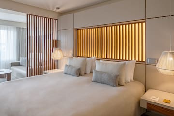 a bed with pillows and lamps in a room