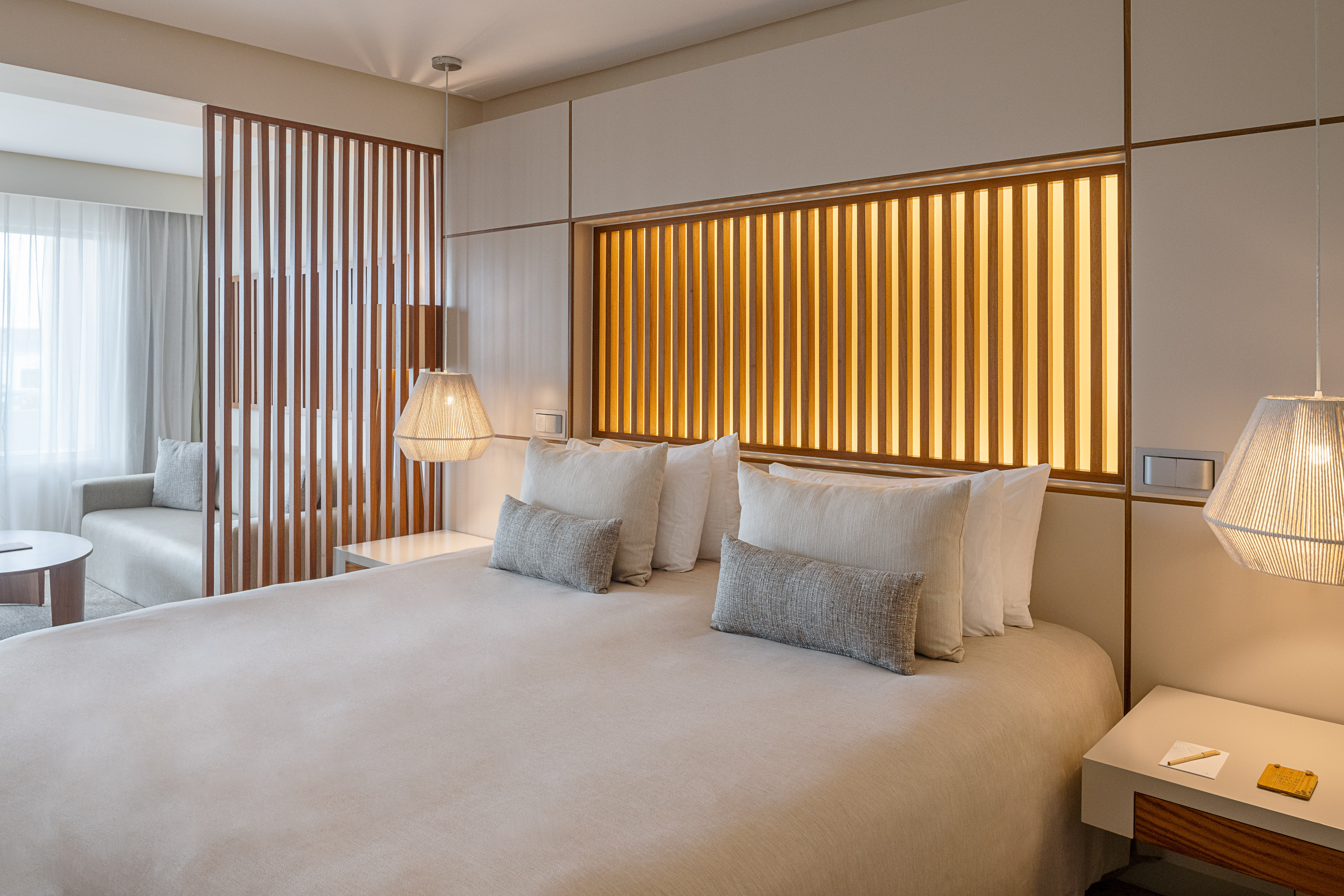 a bed with pillows and lamps in a room