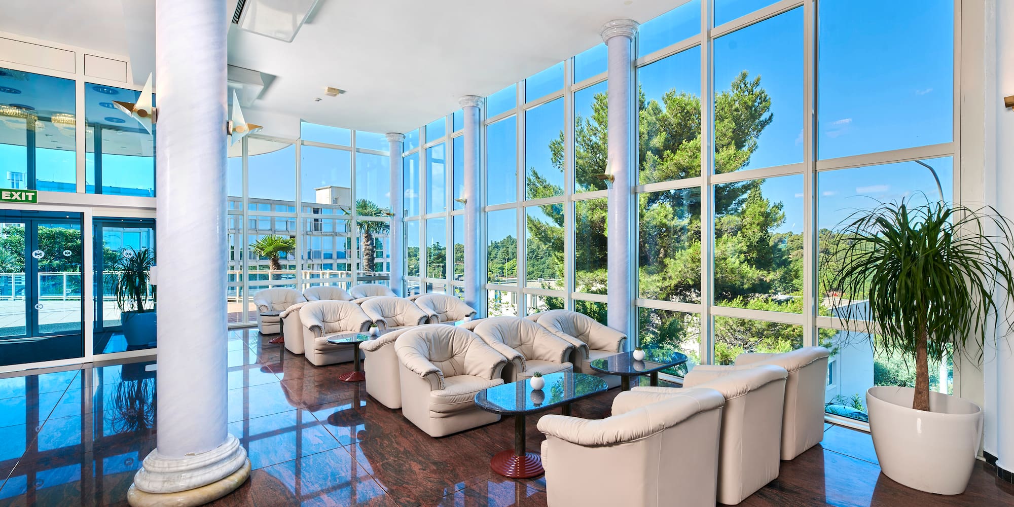 a room with white couches and tables