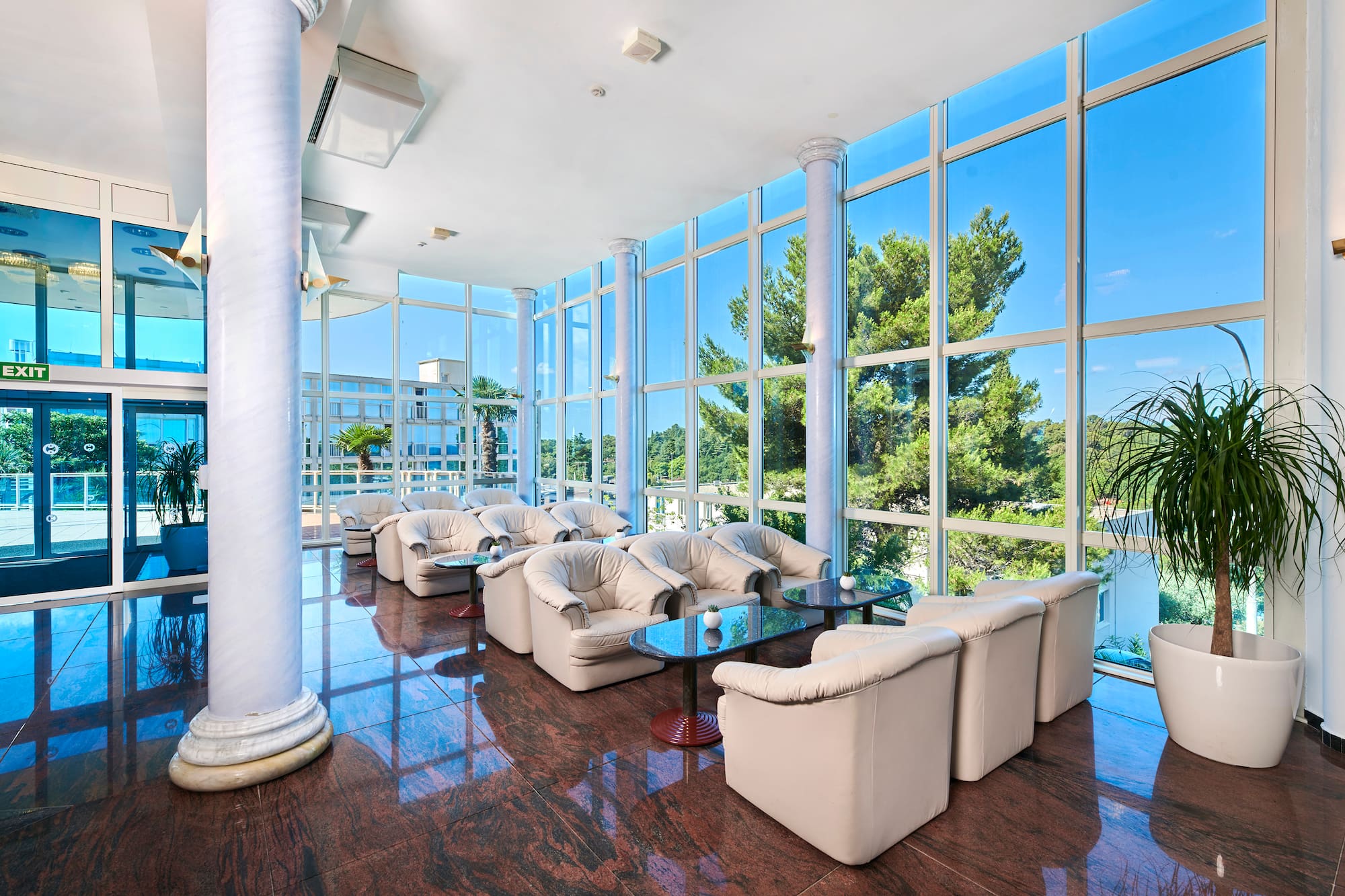 a room with white couches and tables
