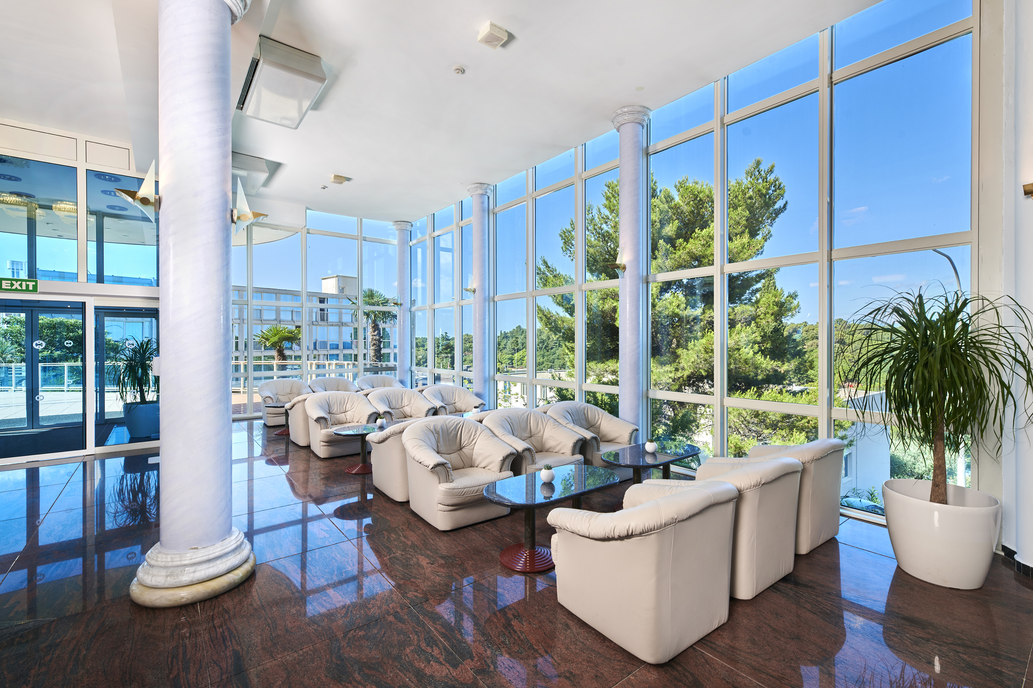 a room with white couches and tables