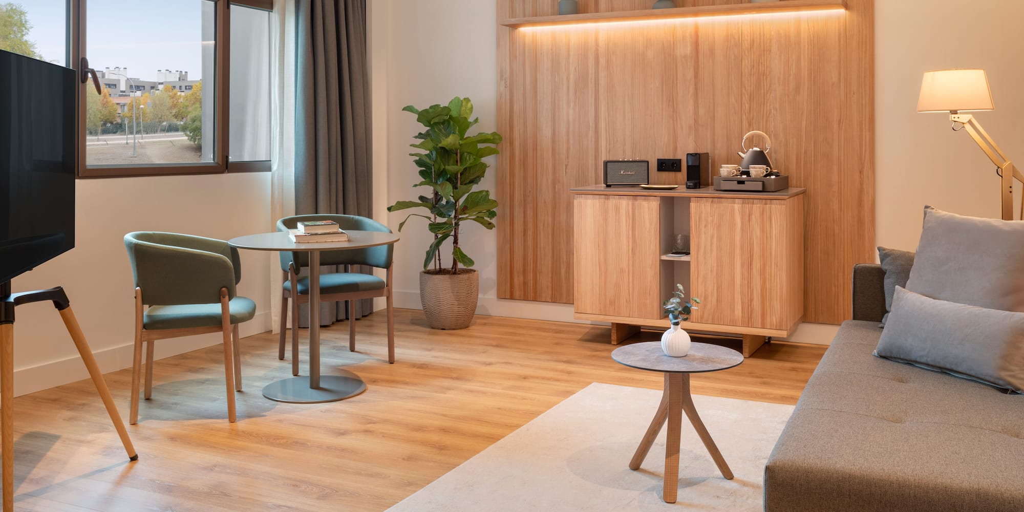 a room with a couch and a table and chairs