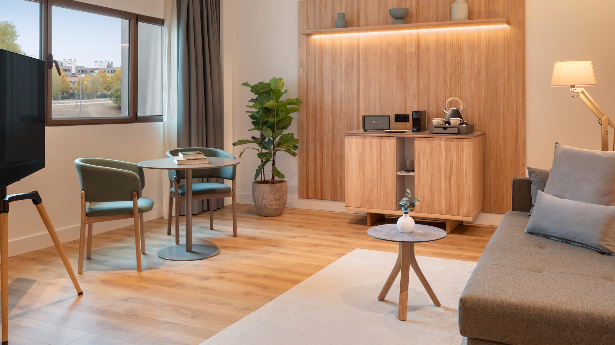 a room with a couch and a table and chairs