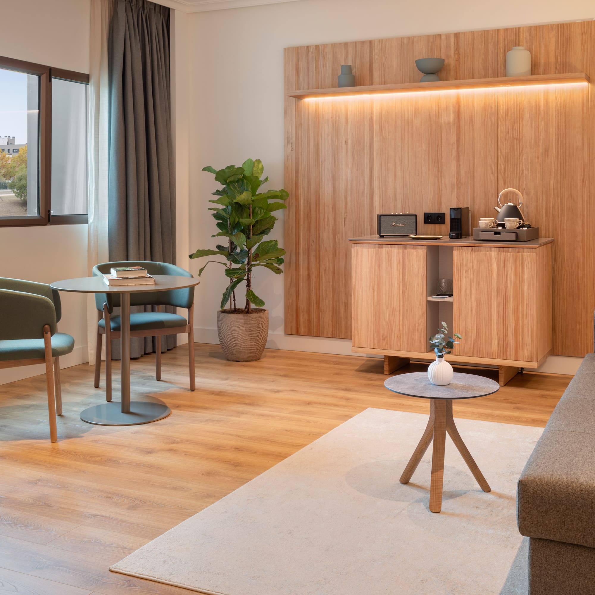 a room with a couch and a table and chairs