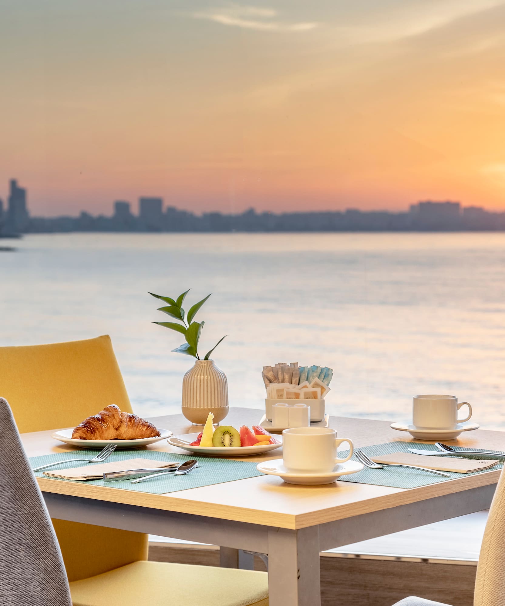 a table with food on it and a view of the water