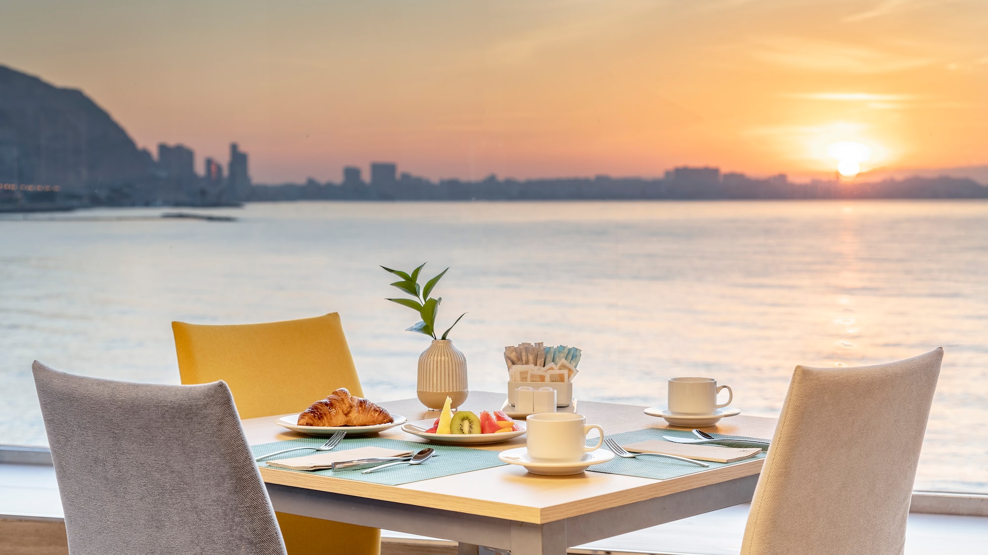a table with food on it and a view of the water